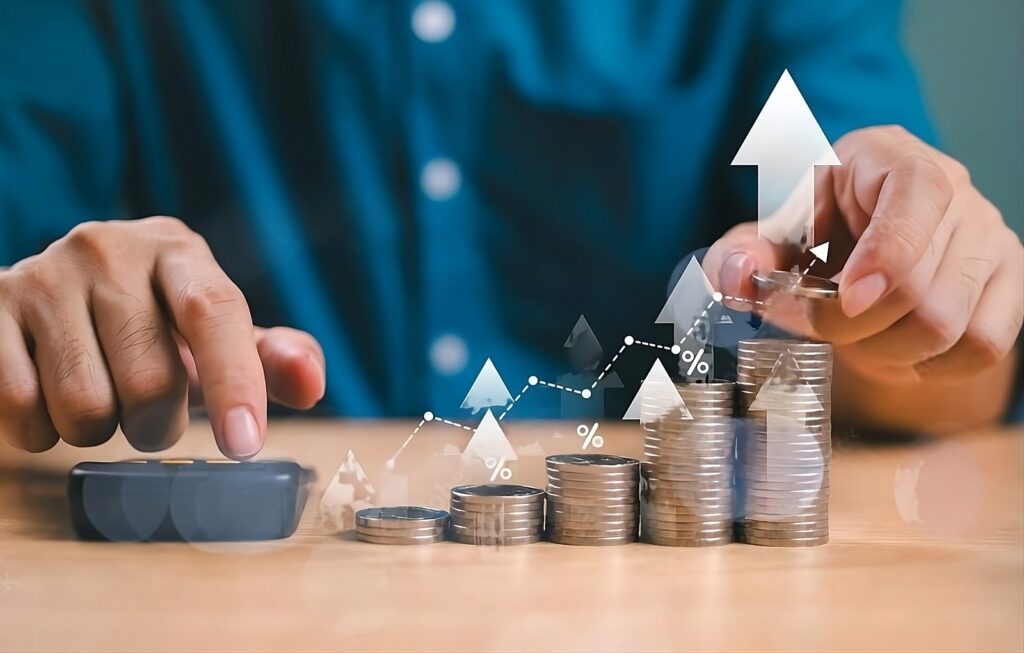 Financial forecasting shown by multiple stacks of coins with varying heights with arrows point above to show financial growth.